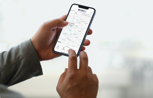 Two hands hold a phone with a map of North Carolina pulled up on the screen